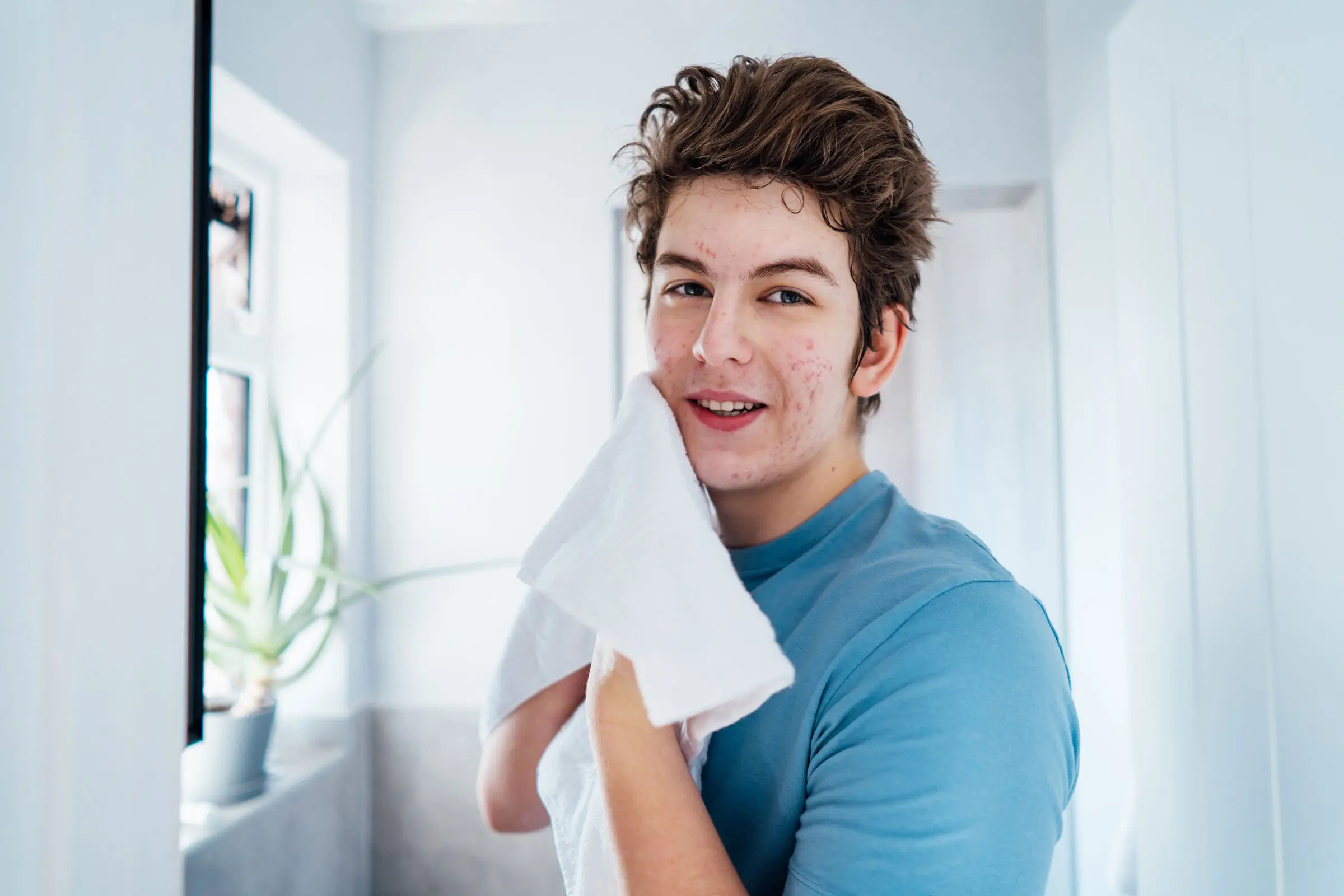 Man washing his face to represent the progress from getting an online dermatologist